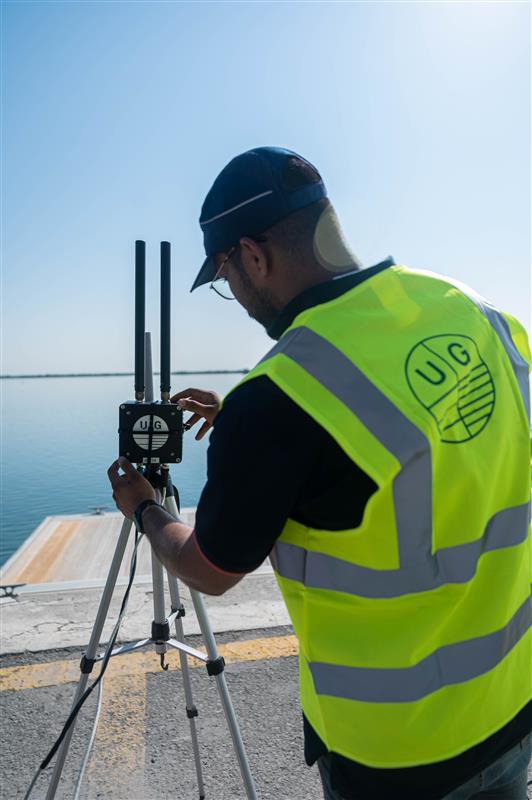 image of a man fixing a Uni-Mesh telemetry system by Unique Group during a project in the UAE
