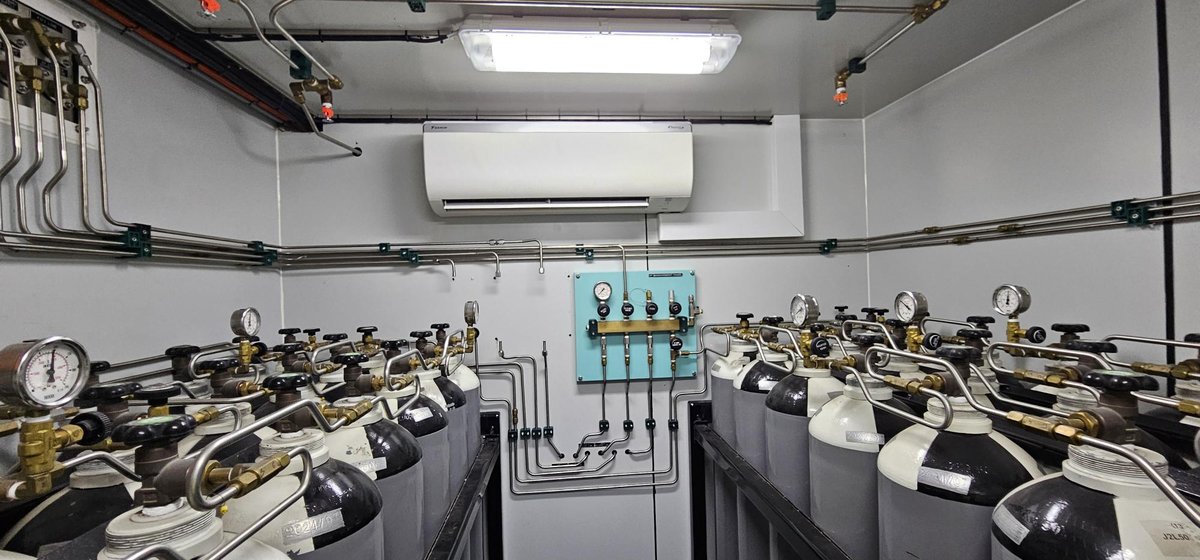 High-pressure air cylinder bank inside a Unique Group air diving system container