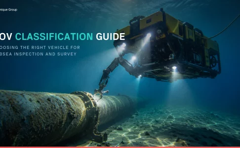 Work-class ROV using its manipulator arm to inspect a subsea pipeline, illustrating ROV classification from Unique Group